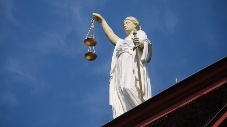 the statue of lady justice is holding two scales