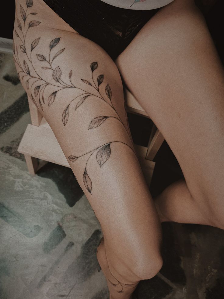 a woman's legs with tattoos on them