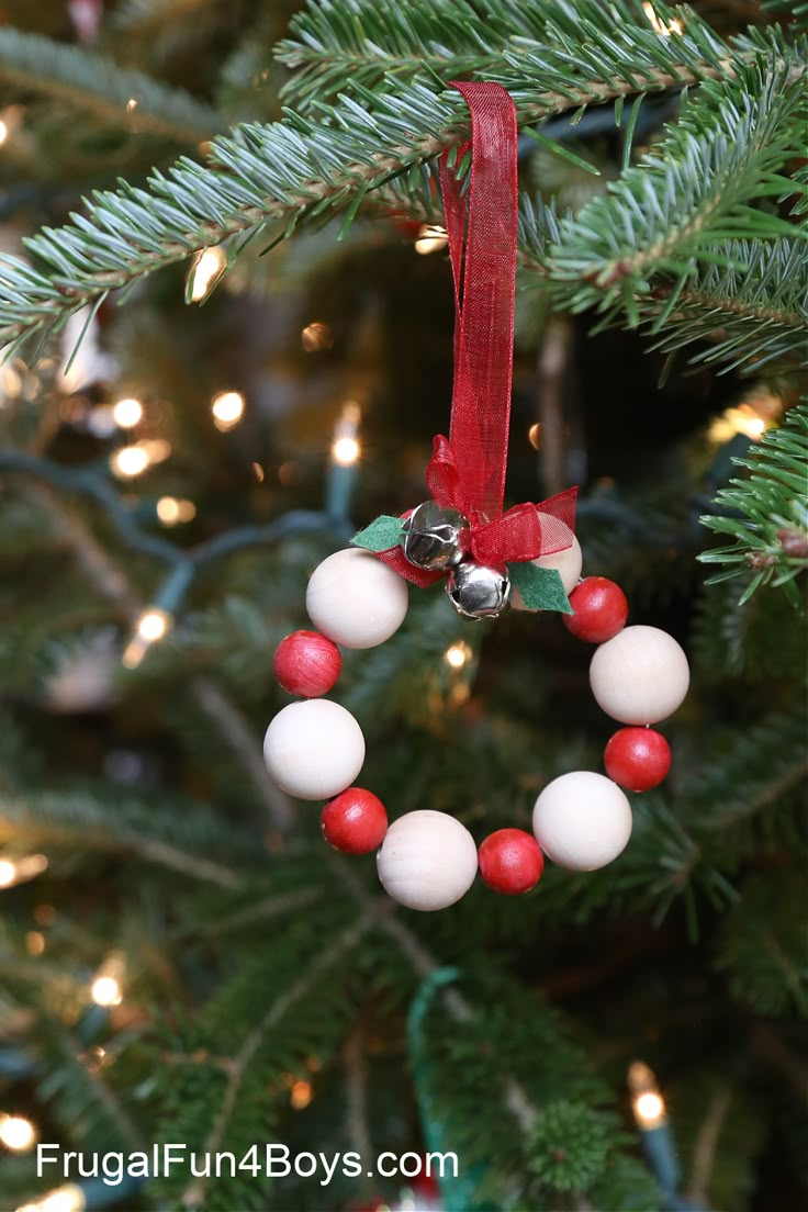 a christmas ornament hanging from a tree with red and white balls on it