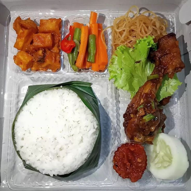 a plastic container filled with rice, meat and veggies