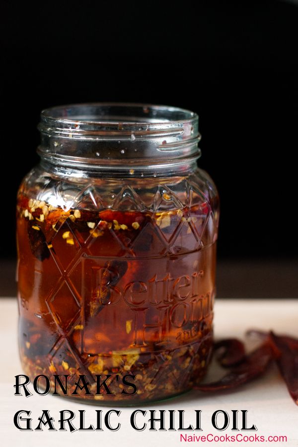 a glass jar filled with liquid sitting on top of a table next to an orange peel