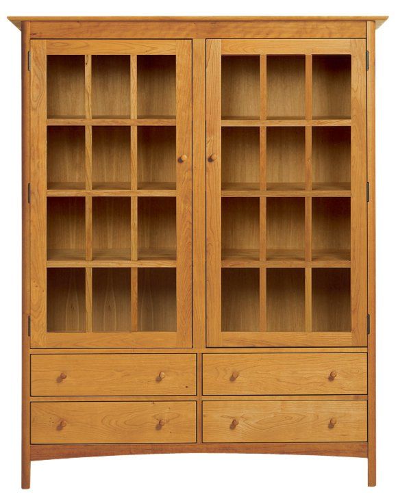 an oak bookcase with glass doors and drawers