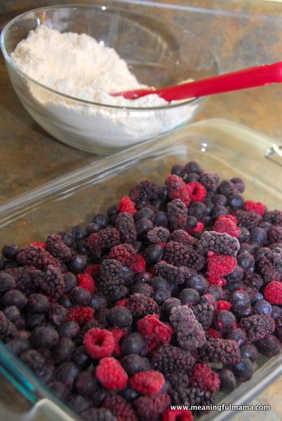 raspberries and blueberries in a bowl with flour