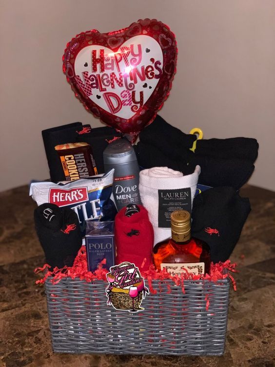 a basket filled with lots of different items on top of a table next to a heart shaped balloon