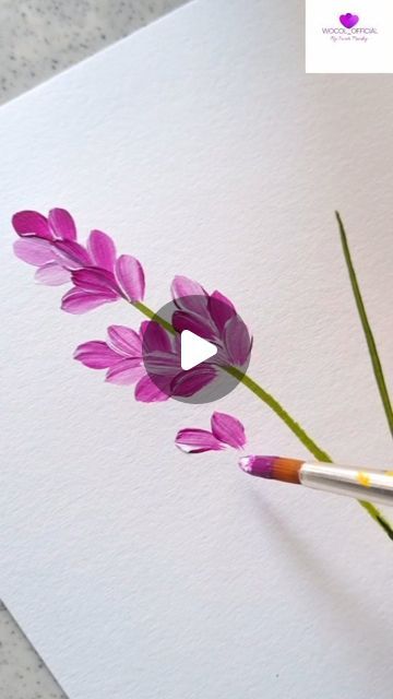 purple flowers are being painted on white paper