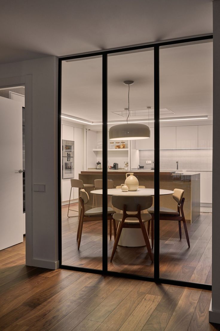 an open kitchen and dining room with sliding glass doors