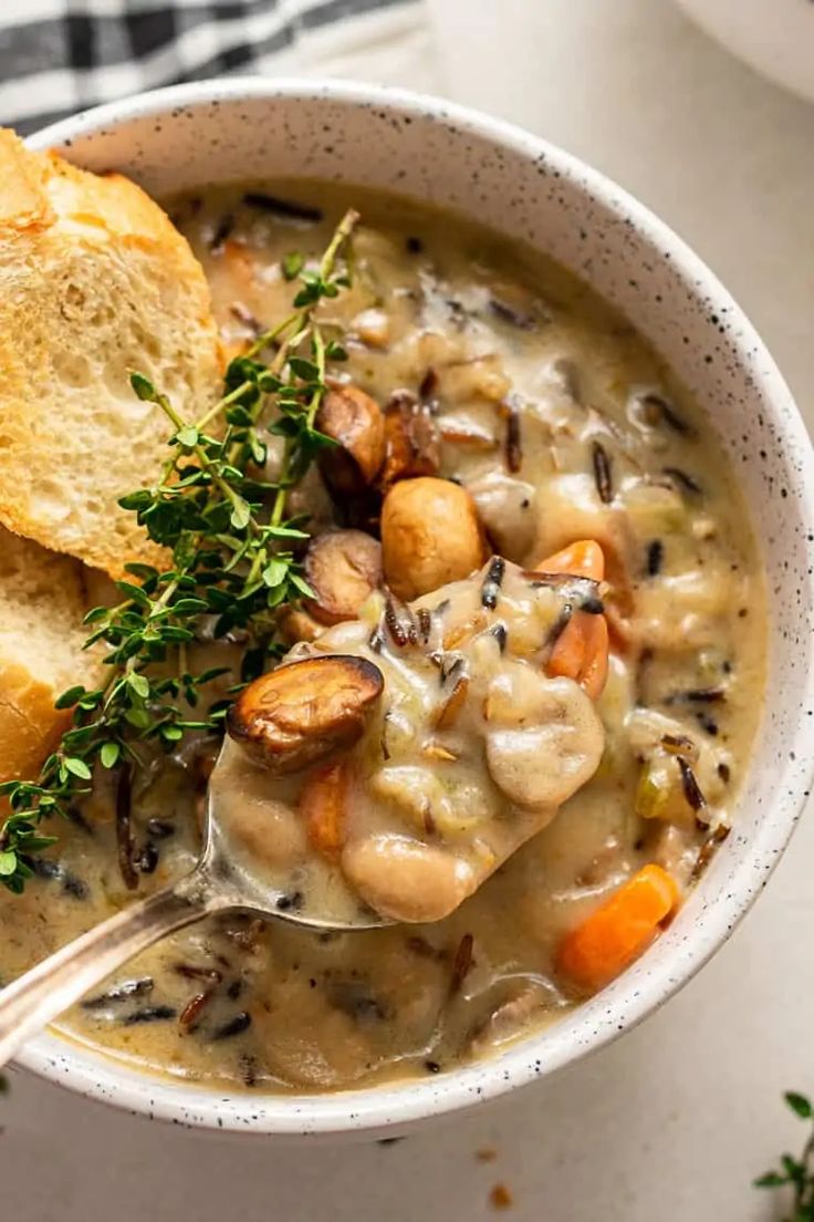 a bowl of soup with bread on the side