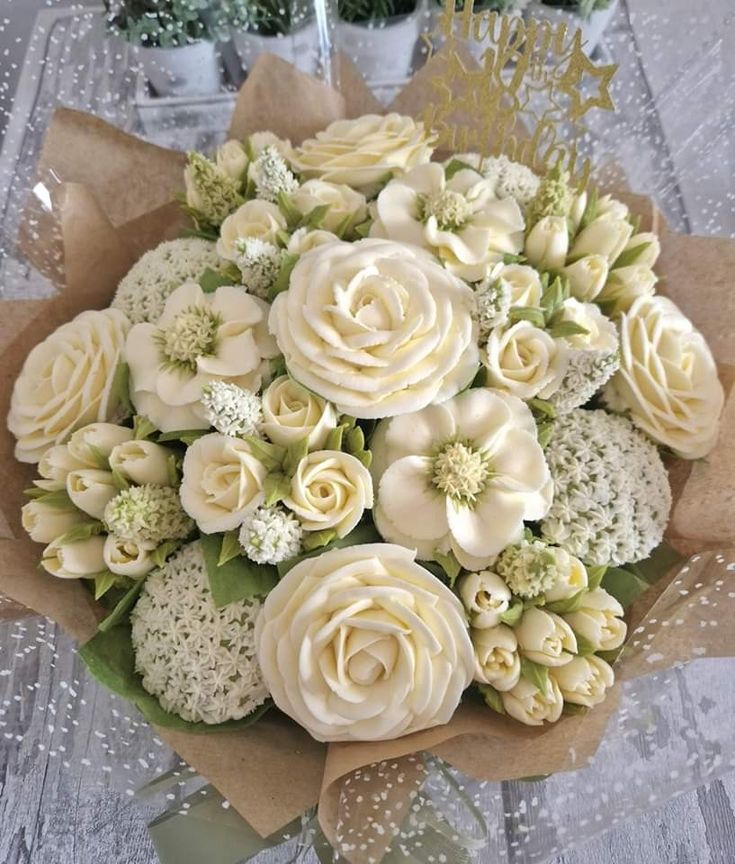 a bouquet of white flowers sitting on top of a table