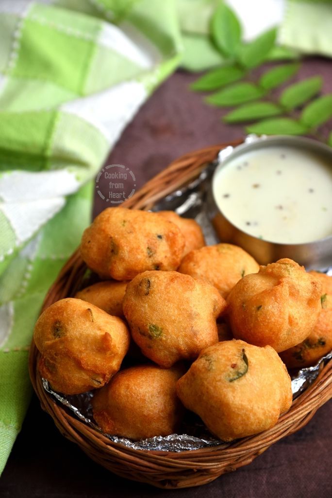 a basket filled with fried food next to a bowl of ranch dressing