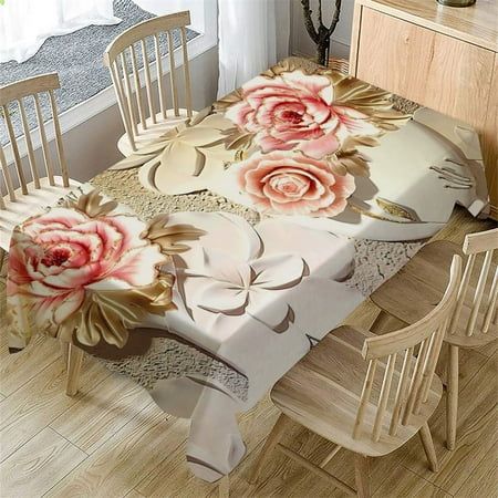 a dining room table with chairs and a flowered table cloth on top of it