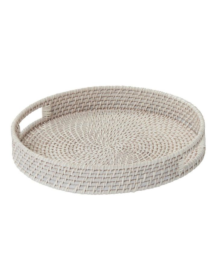 a round white wicker tray with handles