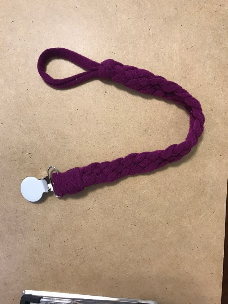 a purple leash with a white tag on it sitting next to an old typewriter