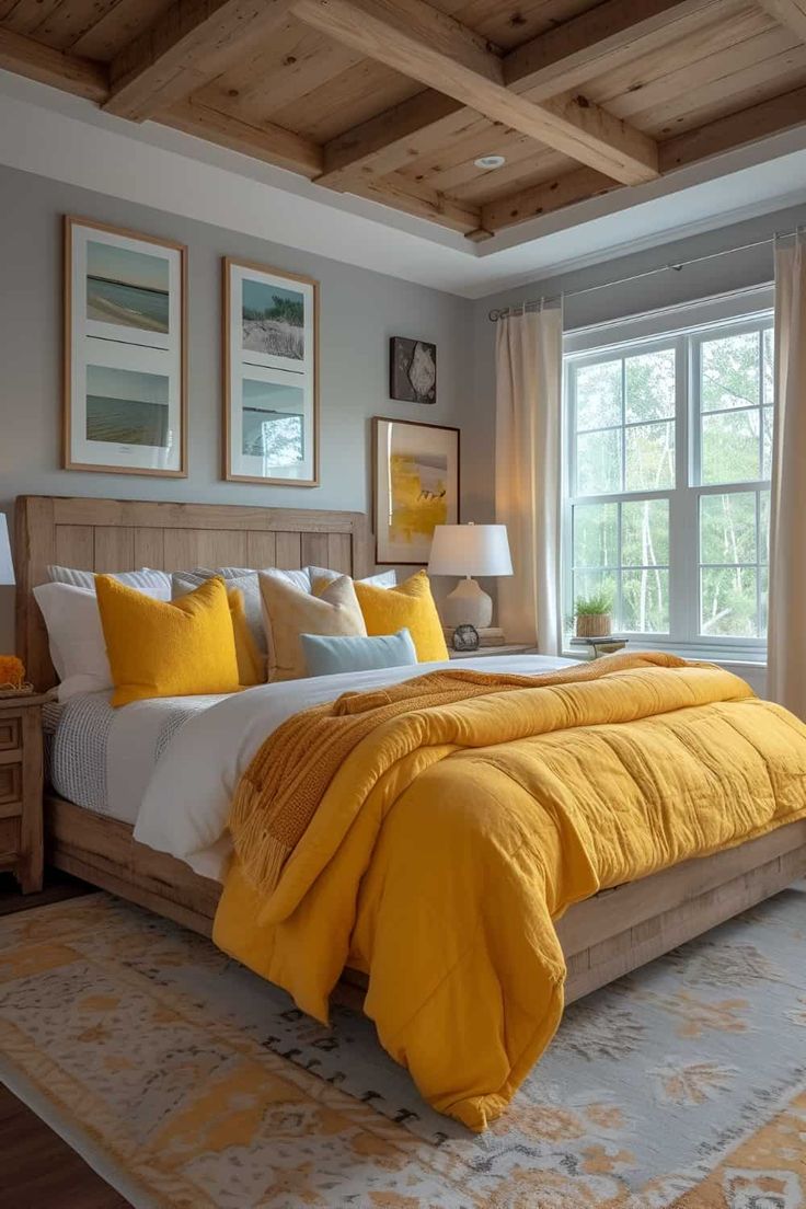 a bed with yellow comforter and pillows in a bedroom