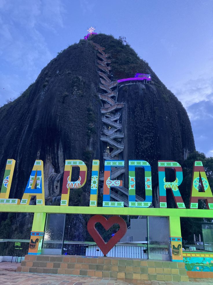 there is a sign that says laperra in front of a large rock formation