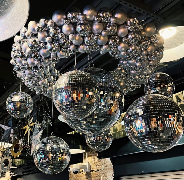 several shiny disco balls hanging from the ceiling