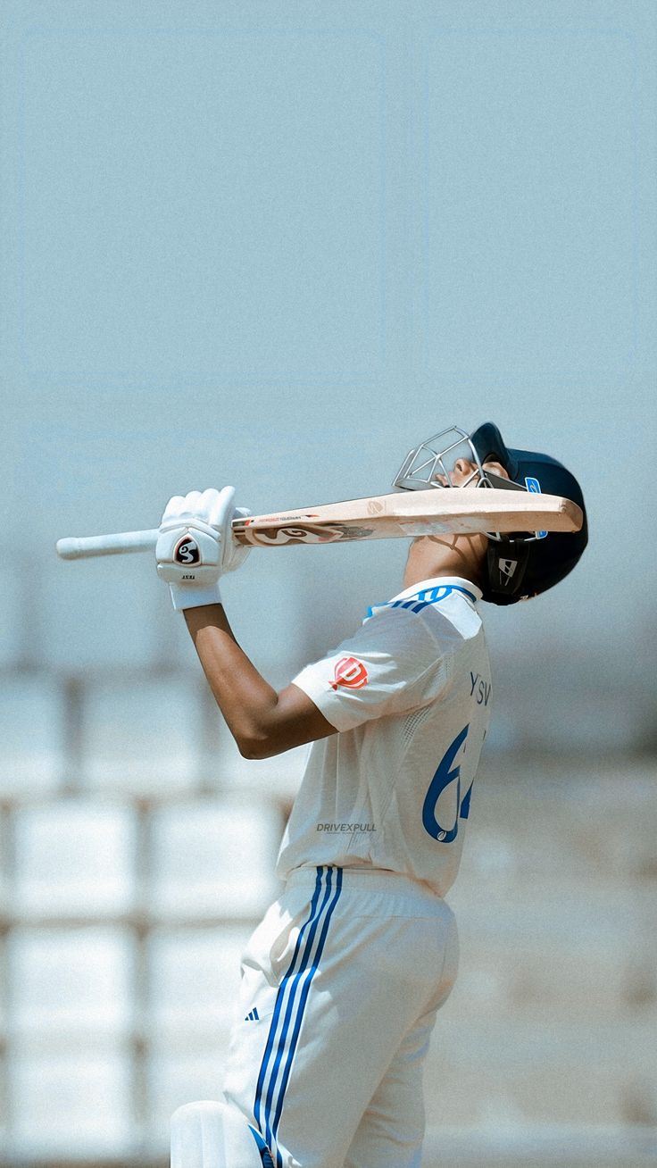 a man holding a baseball bat on top of a field