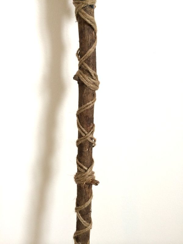 a wooden pole with rope wrapped around it