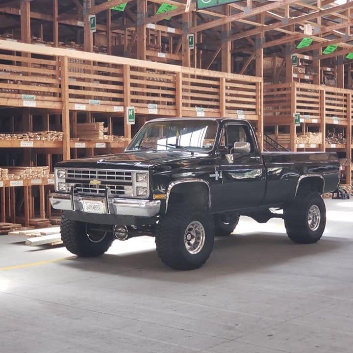 a black pickup truck parked in a warehouse