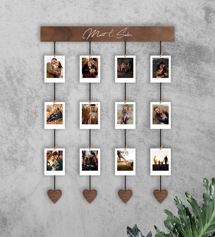 a family photo hanging on a wall with heart shaped magnets and wooden hangers