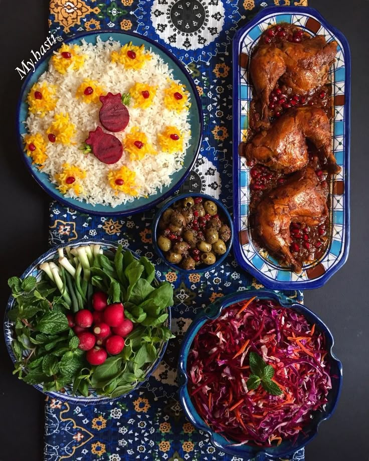 a table topped with bowls filled with different types of food next to rice and veggies