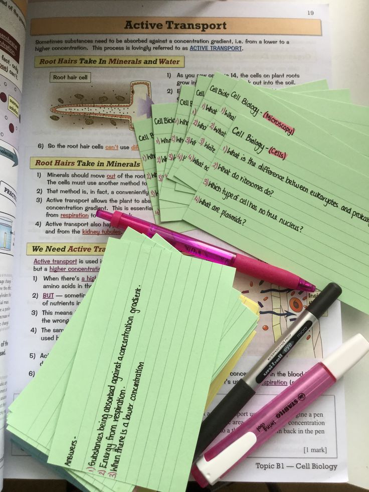 several sticky notes and pens on top of an open book with the pages lined up