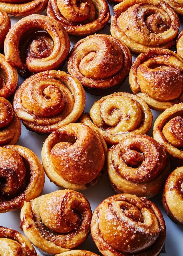 many cinnamon rolls are on a white plate