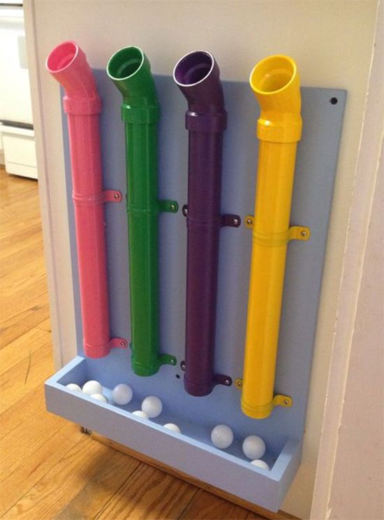 four different colored toothbrushes are in a holder on the wall next to a door