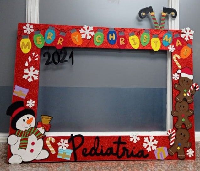 a christmas frame with a snowman and a gingerbread man on the front is decorated