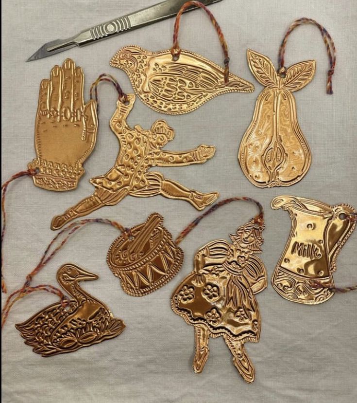 some gold colored metal ornaments and a pair of scissors