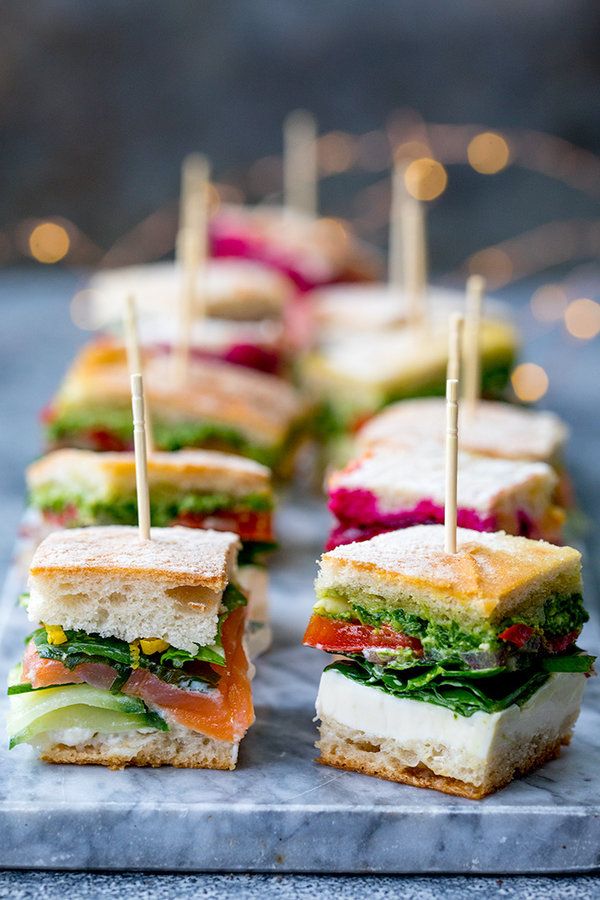 sandwiches with toothpicks are arranged on a tray