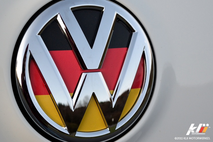 the front emblem of a vw car with german flag on it's side