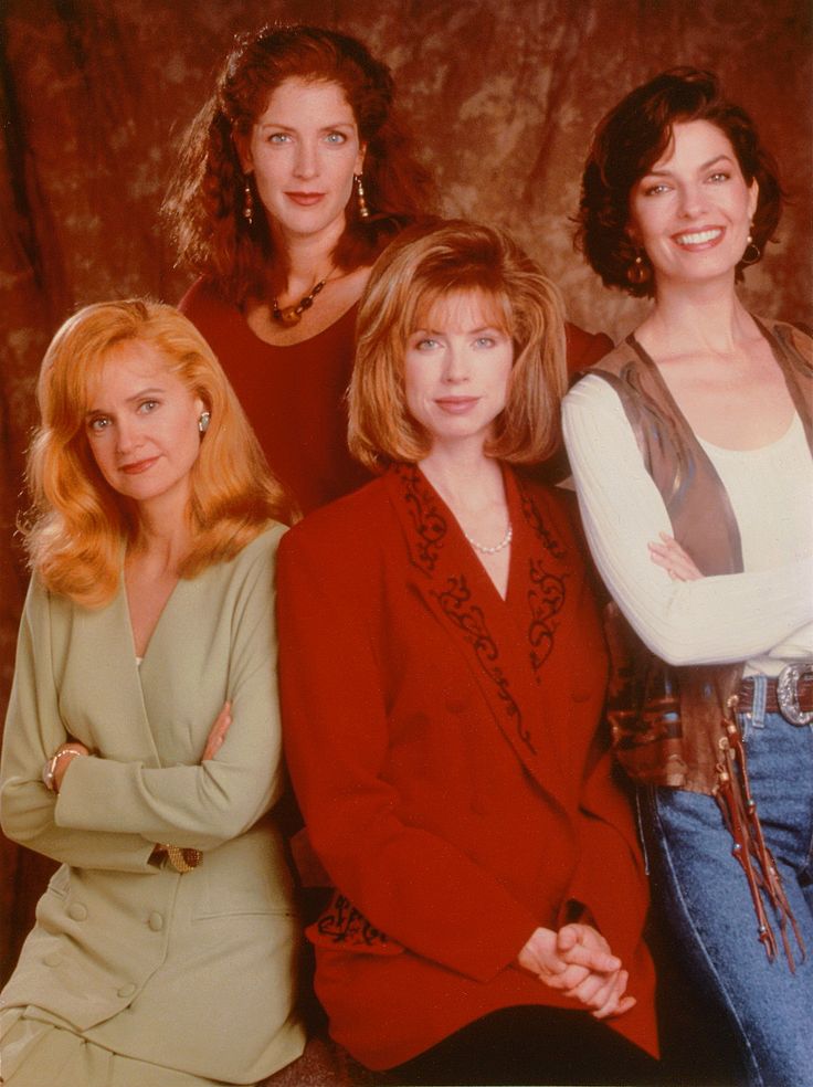 four women are posing for a photo together