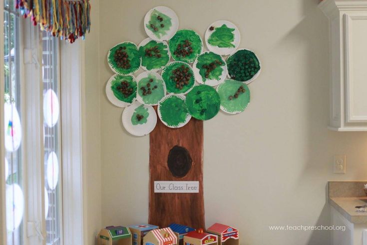 a tree made out of paper plates sitting on top of a kitchen counter