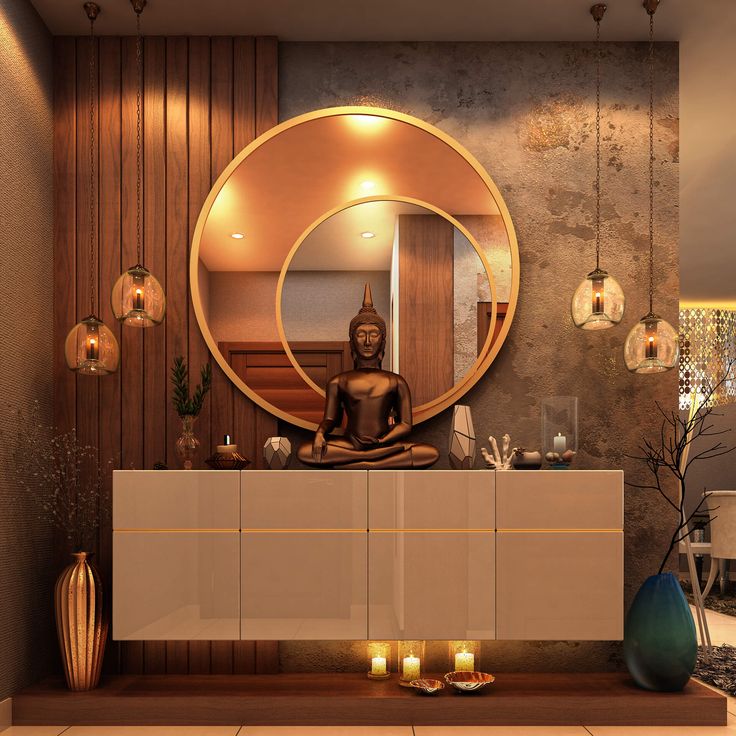 a buddha statue sitting on top of a counter in front of a mirror and candles