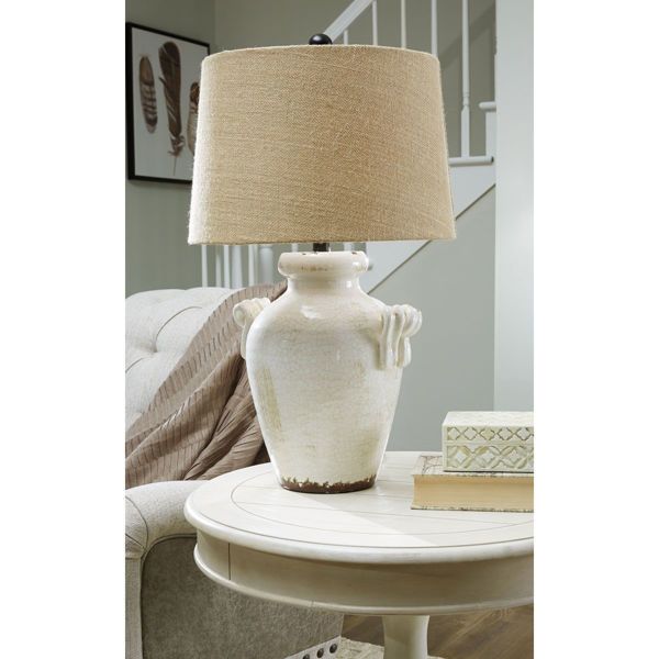 a white table with a lamp on top of it