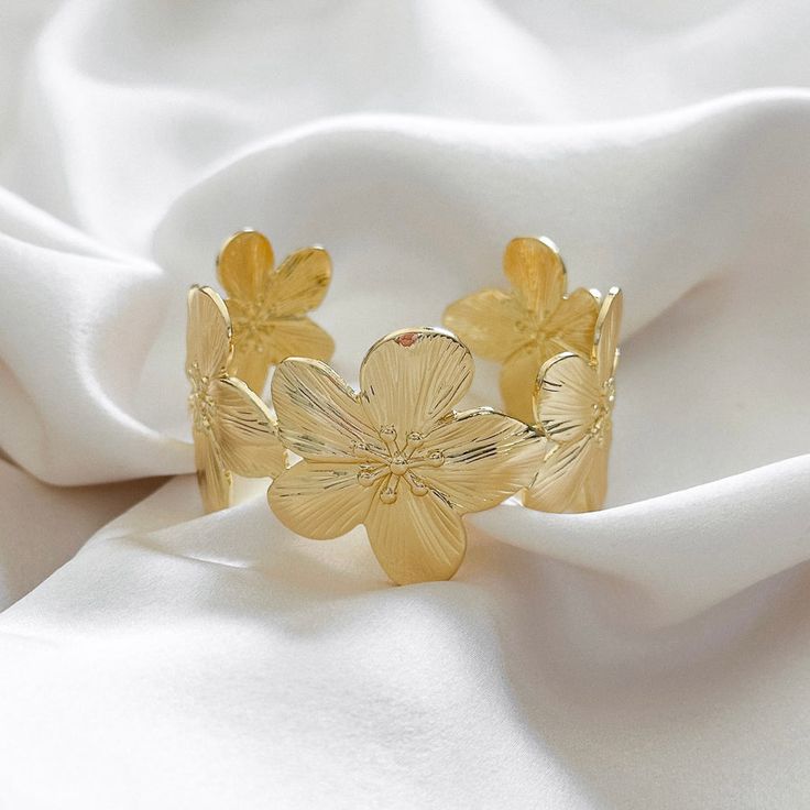 Make a statement with our chunky floral cuff bracelet thats easy to wear and style. Wear alone or layer with other bracelets. 14k Gold Filled Cuff Diameter: 52mm x 34mm Adjustable Hypoallergenic Water resistant & tarnish free Nickel & lead free Floral Cuff Bracelet, Floral Cuff, Cuff Bracelet, Gold Filled, Water Resistant, Cuff, Bracelet, Water, Floral