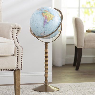 a blue and white globe on a stand in a living room