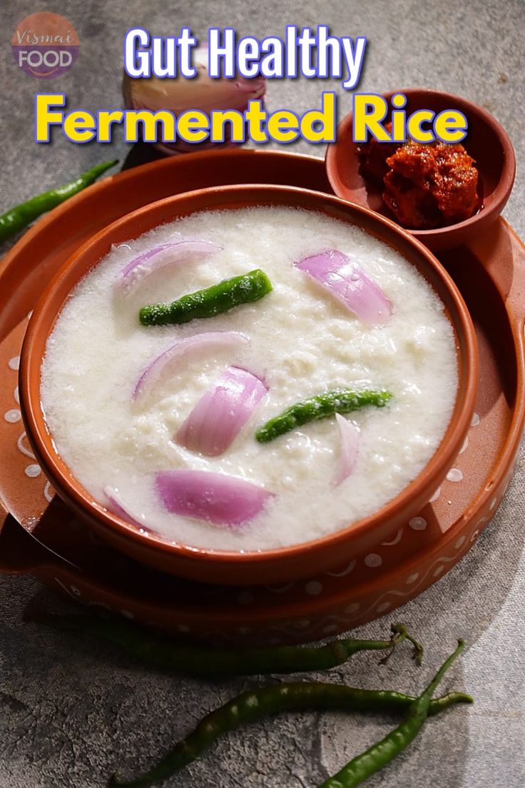 a bowl filled with rice and onions on top of a table next to green beans