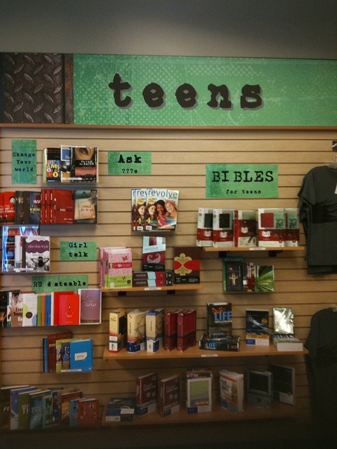 there are many items on the shelves in this store that is selling books and teas