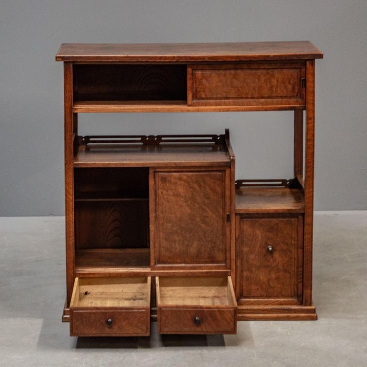 a wooden shelf with drawers and shelves on it