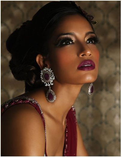 a woman in a red dress with earrings on her head