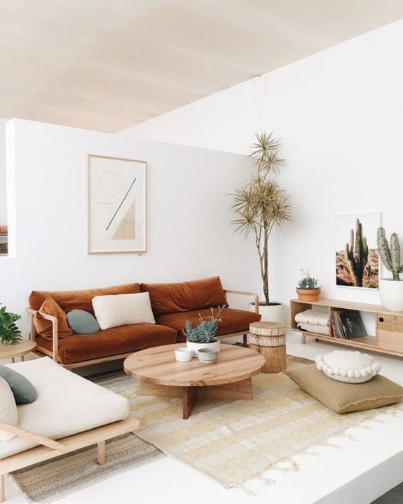 a living room filled with furniture and plants