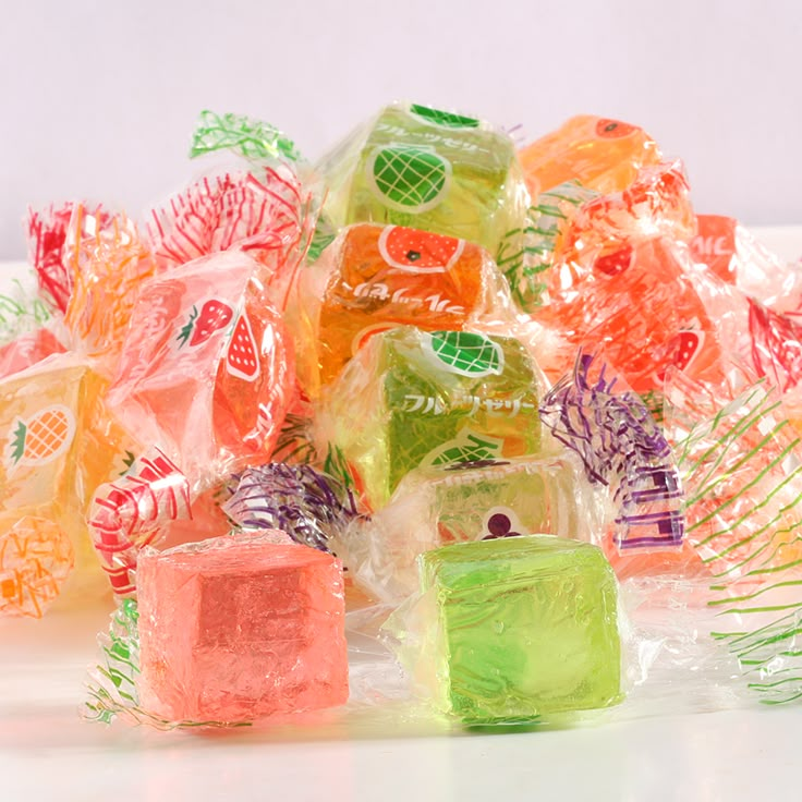 gummy bears are stacked on top of each other in cellophane wrappers