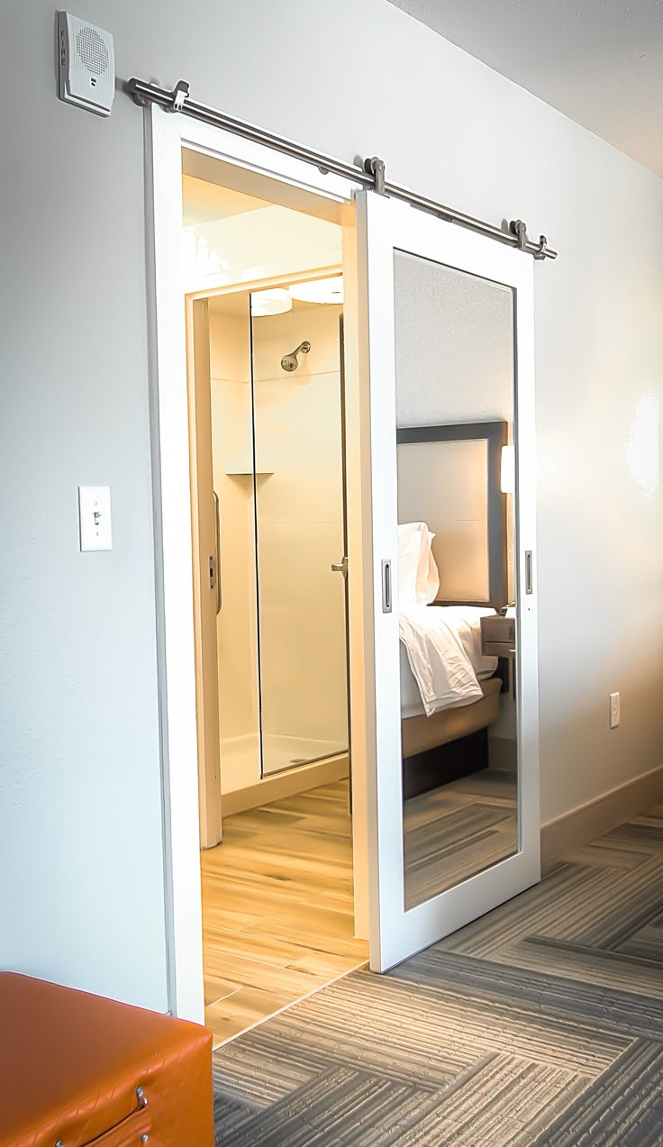 an open door leading to a bedroom with a bed in it