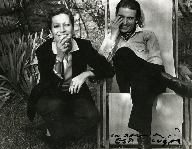 black and white photograph of two people sitting in chairs