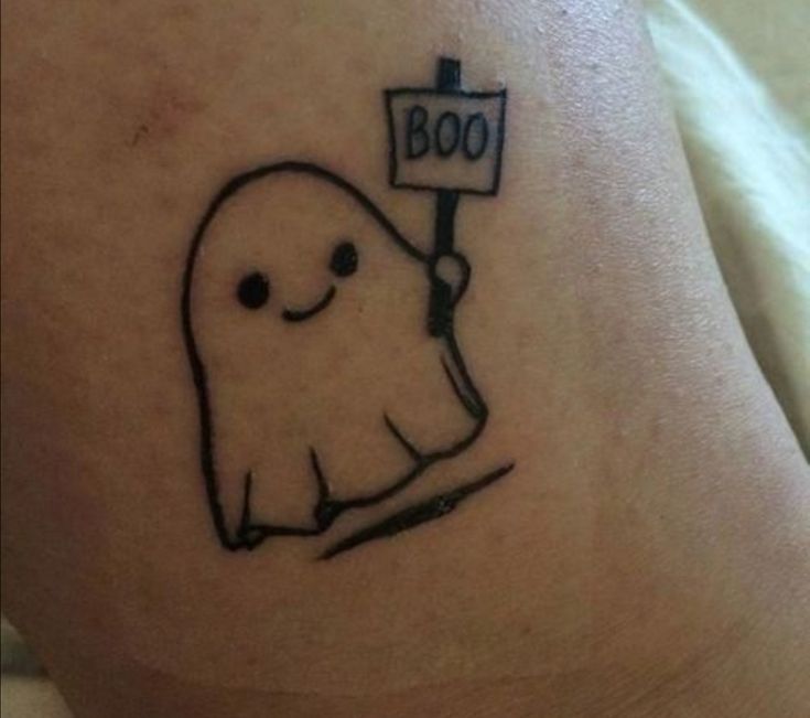 a tattoo with a ghost holding a sign that says boo on it's leg