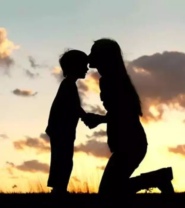 the silhouette of two people holding hands in front of an orange and blue sky with clouds