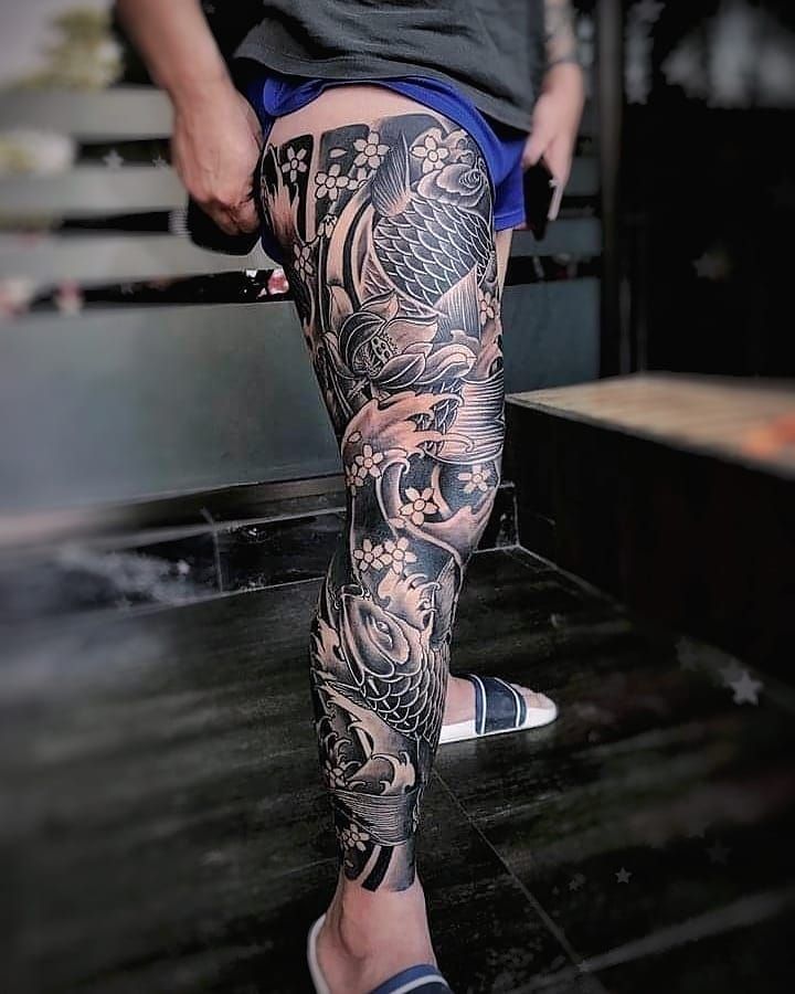 a person with tattoos on their legs and leggings