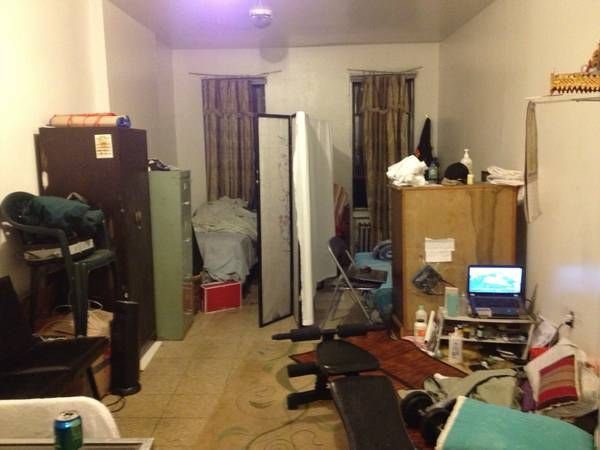 a living room filled with furniture and clutter on the floor next to a doorway