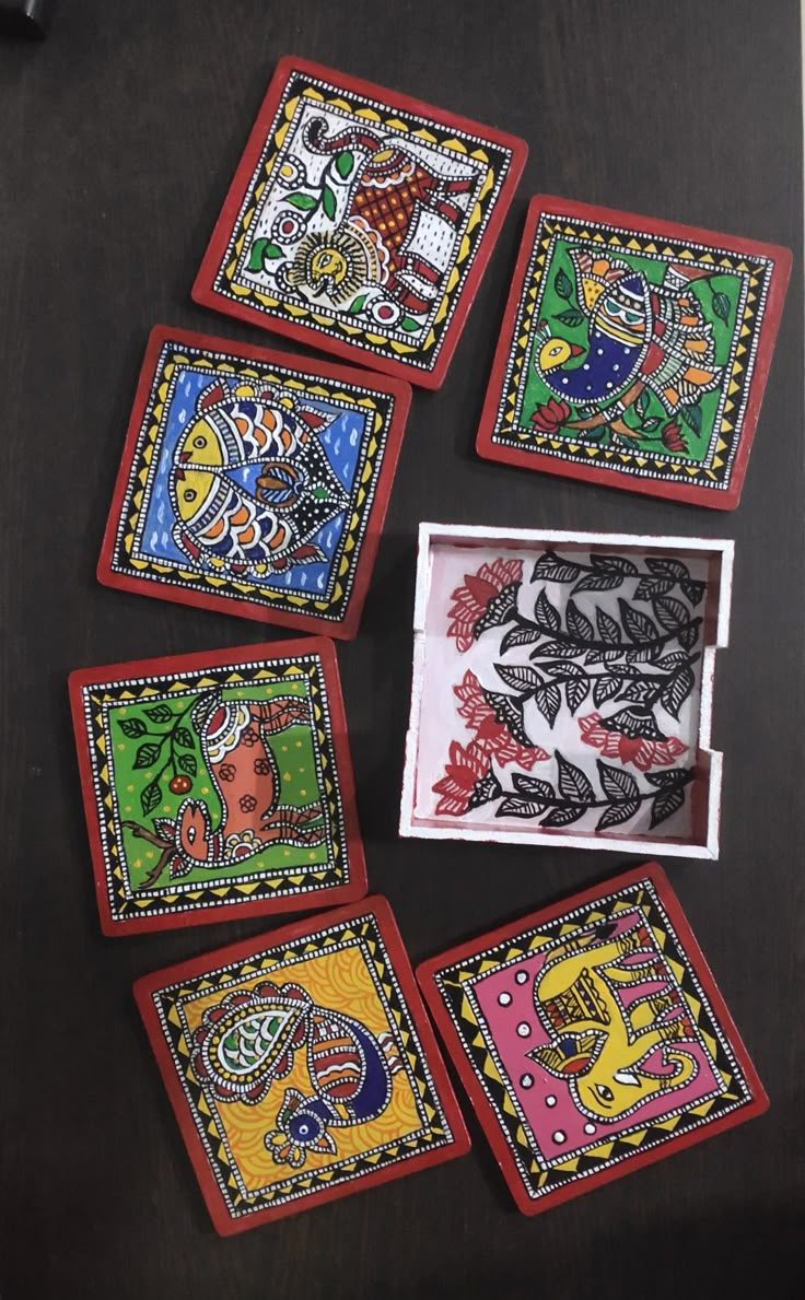 six hand painted coasters with designs on them